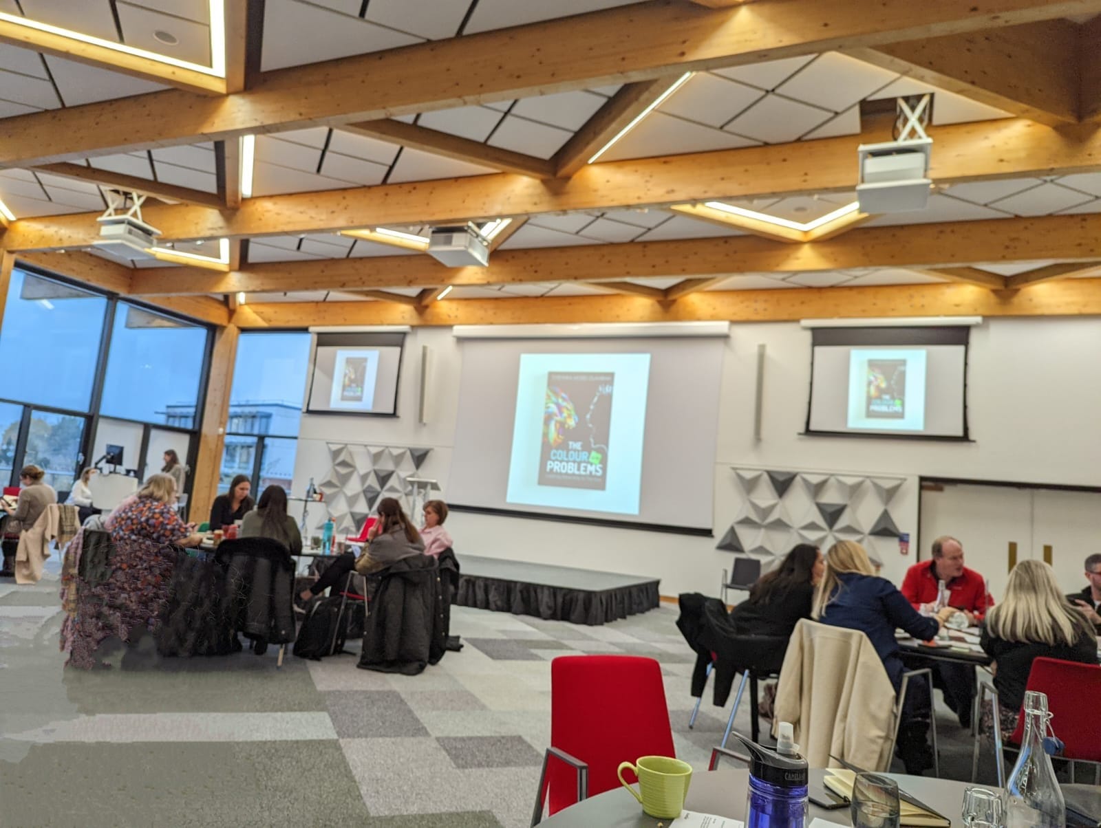 Clasier publishing event with attendees gathered in front of a presentation screen