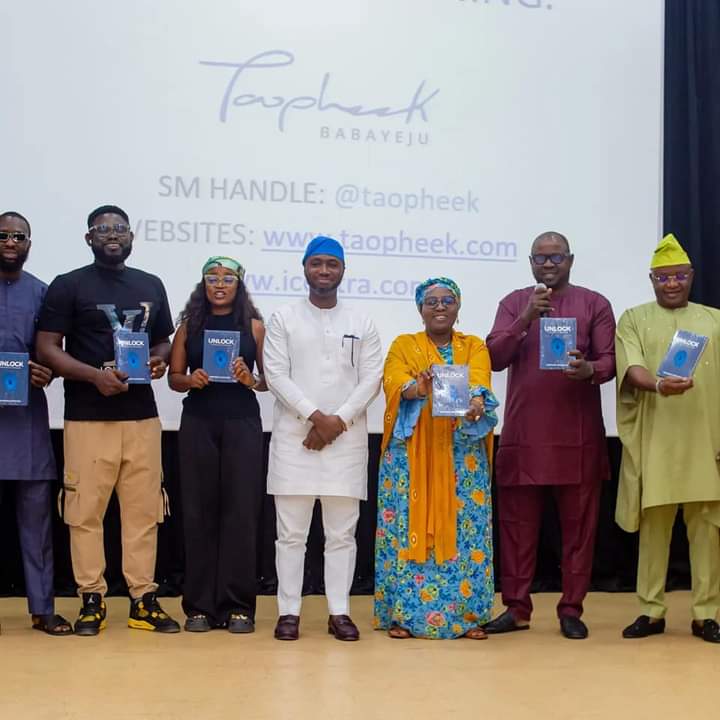 Authors and guests posing with published books at a launch event
